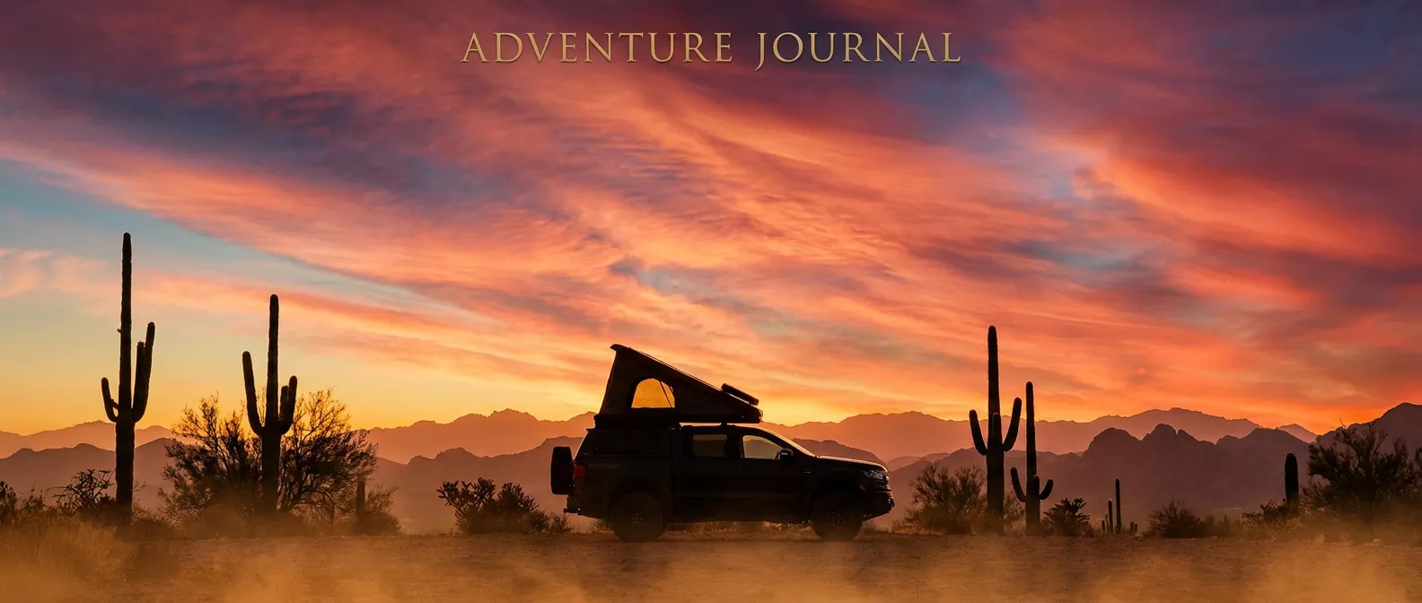 A luxury motorhome silhouetted against an enormous Sonoran sunset